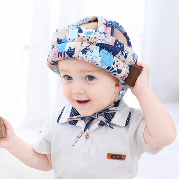 Toddler wearing cute cat print baby safety helmet smiling